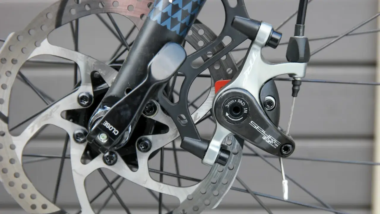 Nahaufnahme einer Fahrradscheibenbremse. Die Bremsbeläge sind sichtbar, was einen Hinweis darauf gibt, wann bremsscheiben wechseln.