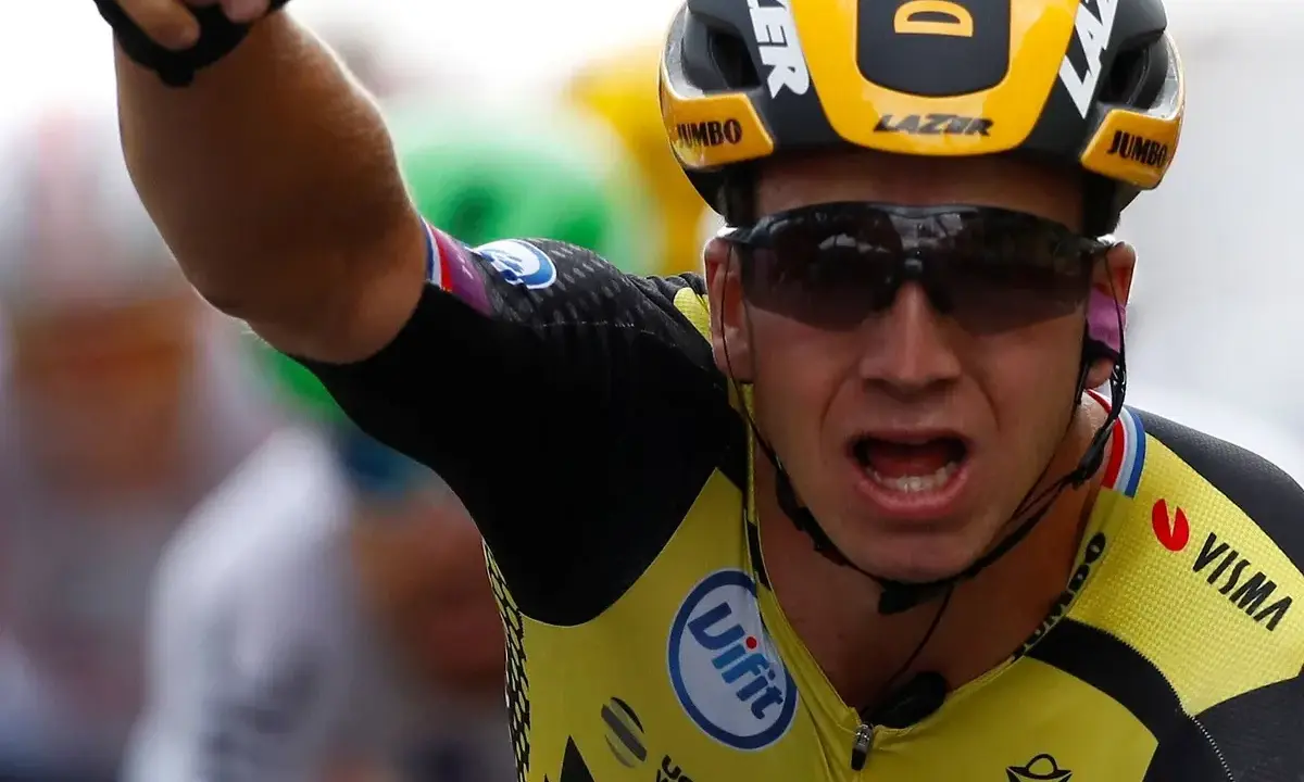 Dylan Groenewegen jubelt nach einem Sieg, sein Arm ist erhoben, sein Mund weit geöffnet.