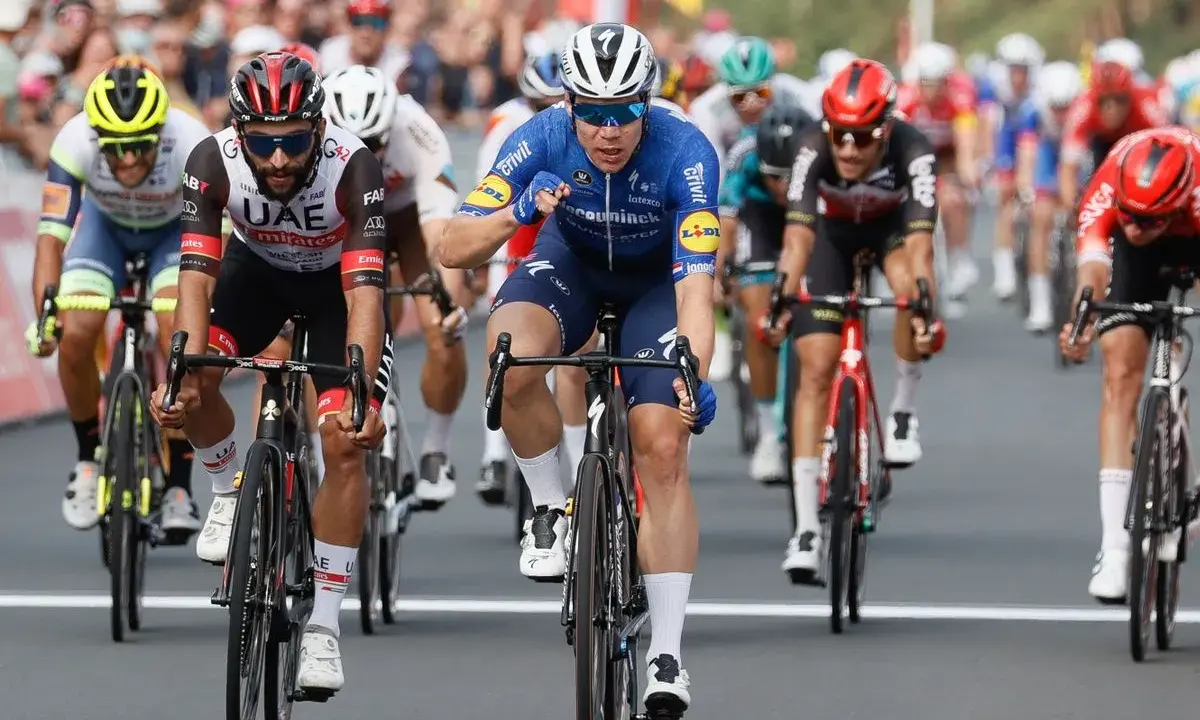 Radfahrer Fabio Jakobsen im blauen Trikot kämpft sich im Sprint durch das Peloton.