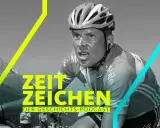 Jan Ullrich im Rennrad-Trikot, mit verschwitztem Gesicht und blutiger Nase. Ein Symbol für seinen Absturz und die Höhen des Radsports.