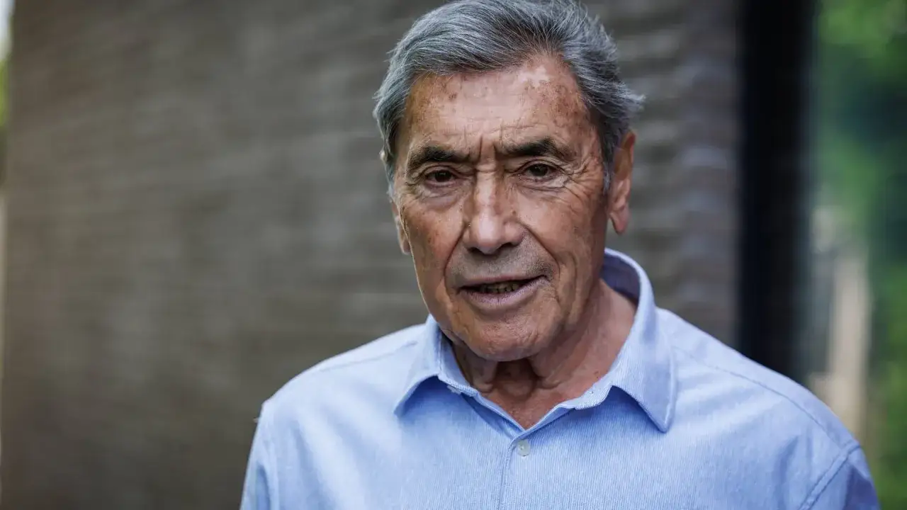 Porträt von Eddy Merckx heute, dem legendären Radfahrer, mit grauem Haar und einem blauen Hemd.